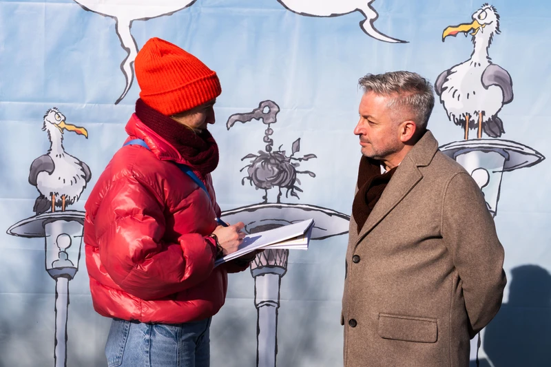 Lara Klewin interviewt Künstler Frank Bahr vor seinem XXL-Cartoon.
