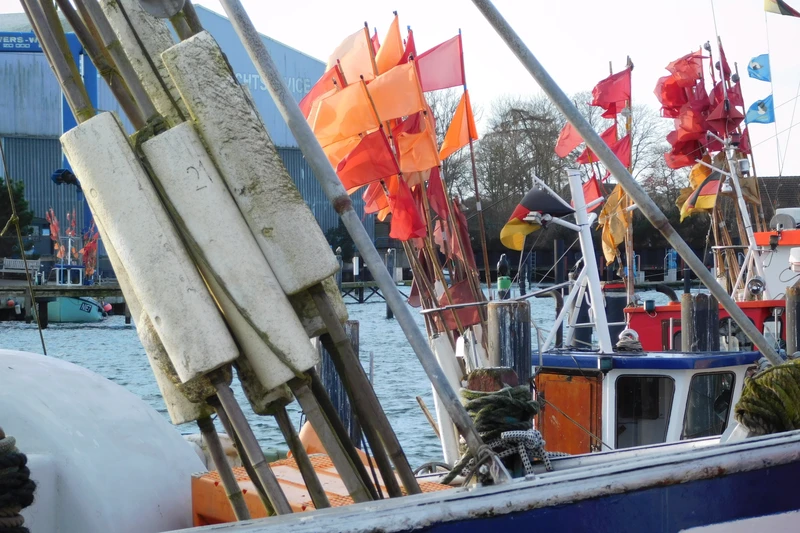 Foto von vielen kleinen roten und orangenen Fahnen auf einem kleinen Boot